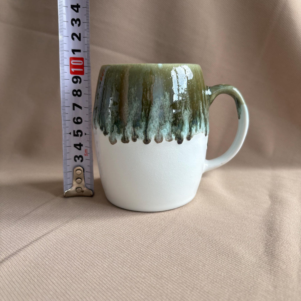 Grey & White Drip Glaze Stoneware Mug beside a ruler for size reference, showcasing its unique glaze.