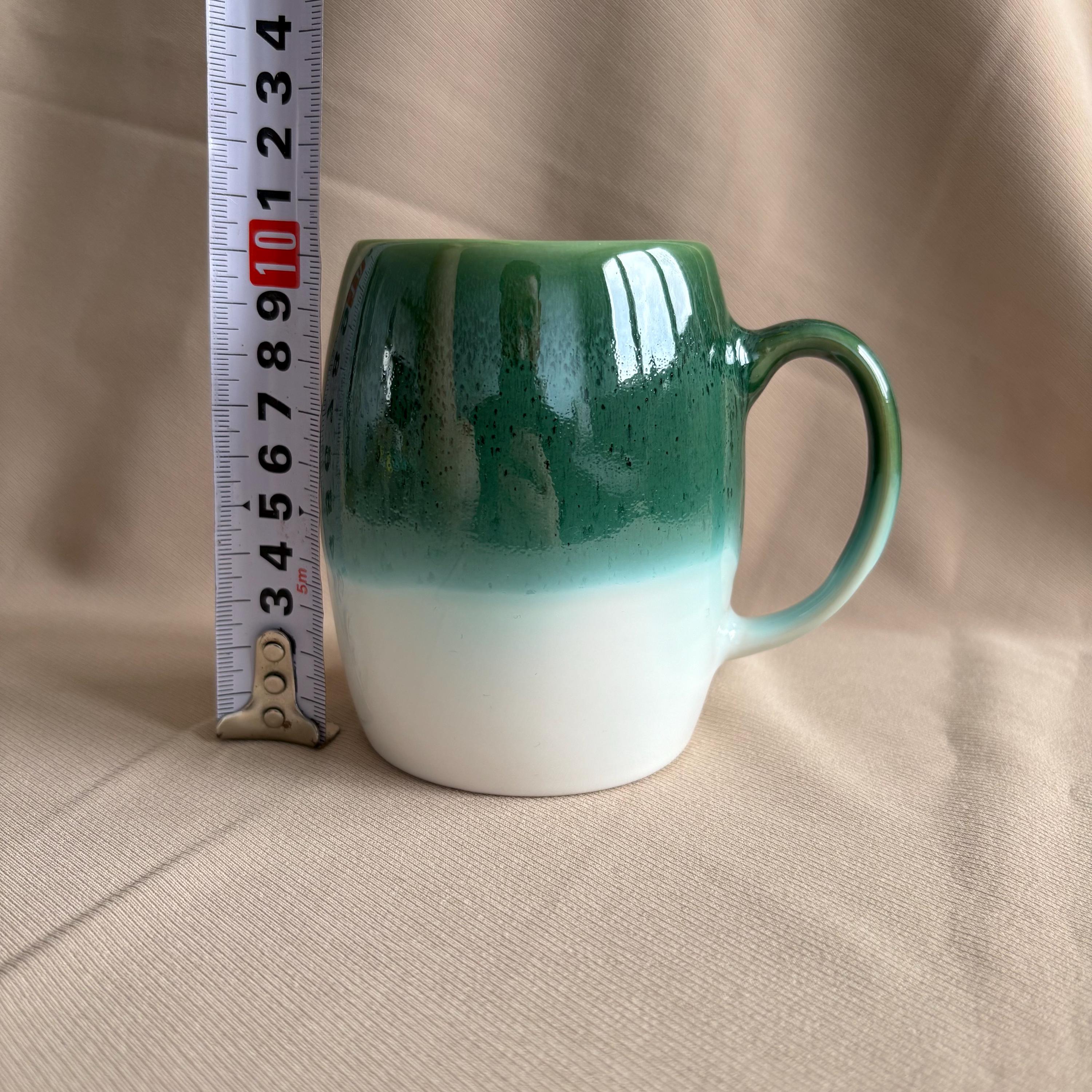 Dark Green & White Drip Glaze Stoneware Mug next to a measuring tape for size reference.