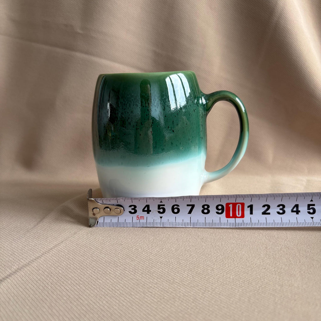 Dark Green & White Drip Glaze Stoneware Mug displayed next to a measuring tape.